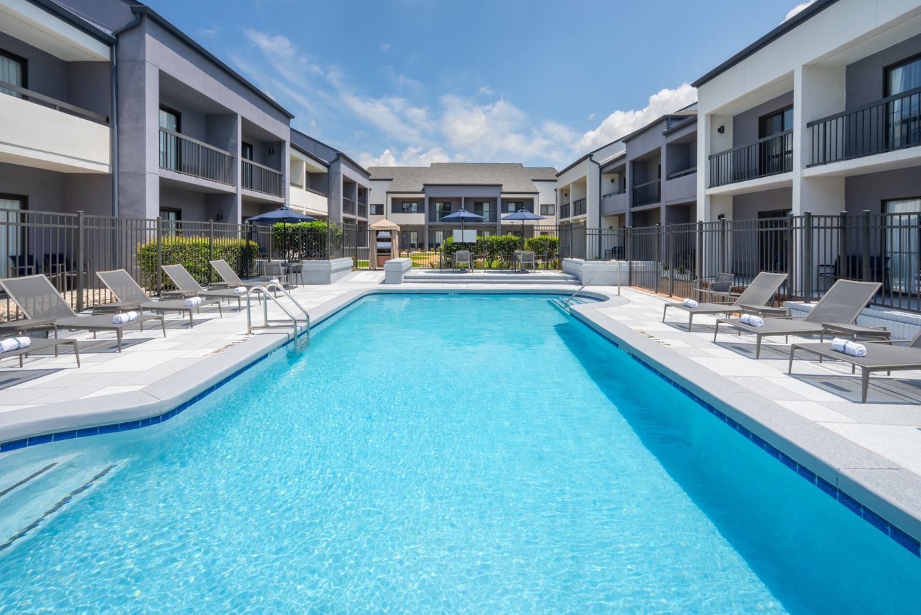 Outdoor courtyard pool with lounge chairs at Courtyard Atlanta Duluth